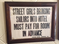 A sign for customers on the wall of Arnold's Bar and Grill.